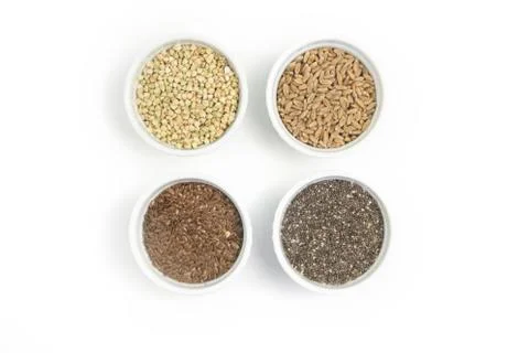 Collection of different groats on white background. Top view of buckwheat, chia Stock Photos