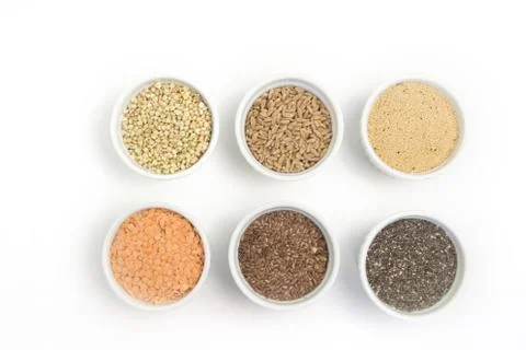 Collection of different groats on white background. Top view of buckwheat, chia Stock Photos