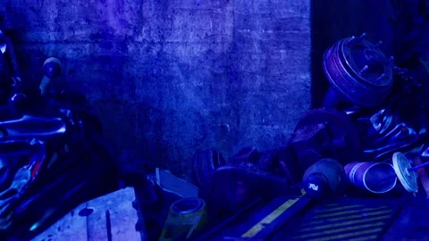 Collection of discarded objects in a dimly lit urban setting Stock Footage 342808888