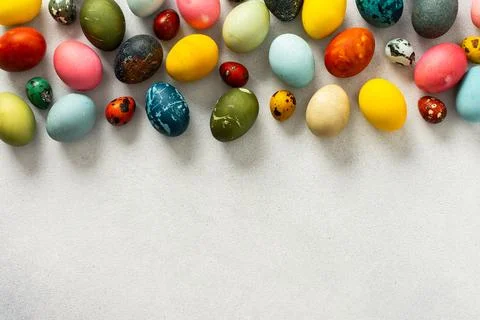 A collection of Easter eggs in bright colors and patterns is displayed on a.. Stock Photos