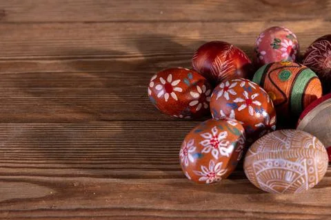 A collection of Easter eggs with brown colors lying on old boards. Stock Photos