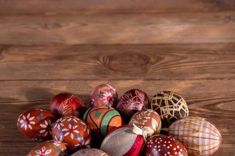 A collection of Easter eggs with brown colors lying on old boards. Stock Photos