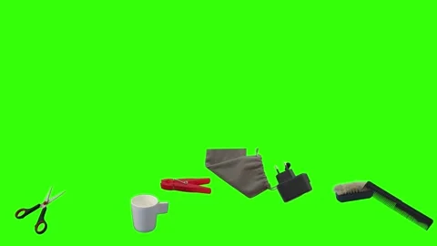 Collection of everyday objects falling against a green screen background Stock Footage 340387099