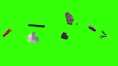 Collection of everyday objects falling against a green screen background Stock Footage 340387101