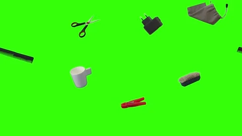 Collection of everyday objects falling against a green screen background Stock Footage 340387105