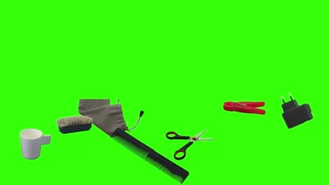 Collection of everyday objects falling against a green screen background Stock Footage 340387106