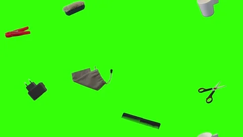 Collection of everyday objects falling against a green screen background Stock Footage 340387108