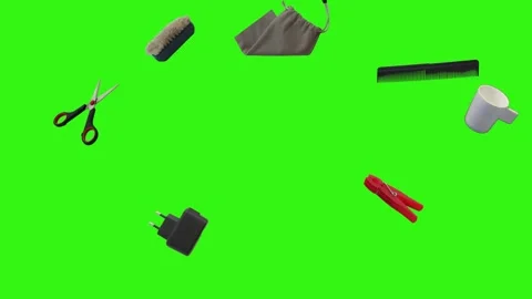 Collection of everyday objects falling against a green screen background Stock Footage 340387123