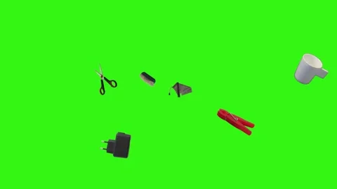 Collection of everyday objects falling against a green screen background Stock Footage 340387127