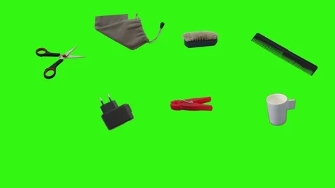 Collection of everyday objects falling against a green screen background Stock Footage 340387135