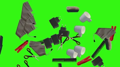 Collection of everyday objects falling against a green screen background Stock Footage 340387144