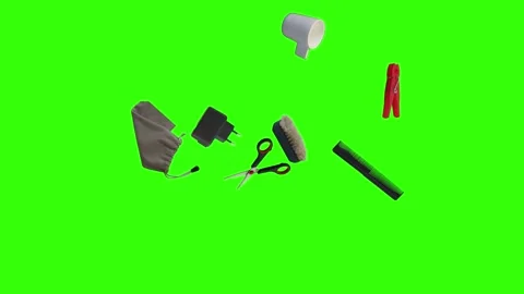 Collection of everyday objects falling against a green screen background Stock Footage 340387151