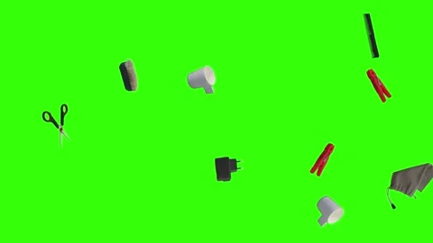 Collection of everyday objects falling against a green screen background Stock Footage 340387158