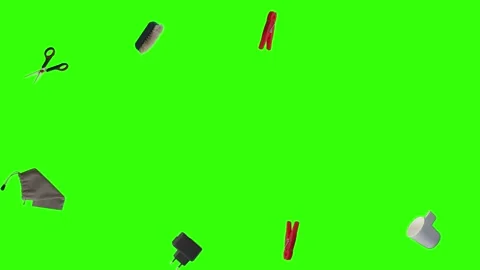 Collection of everyday objects falling against a green screen background Stock Footage 340387168