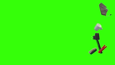Collection of everyday objects falling against a green screen background Stock Footage 340387171