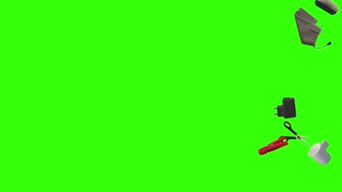Collection of everyday objects falling against a green screen background Stock Footage 340387173