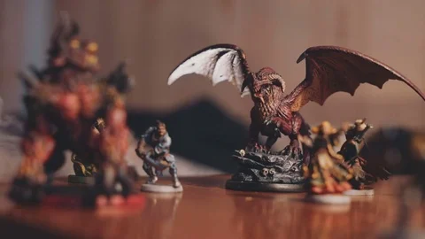 Collection of fantasy roleplay figures on table, smoke in background Stock Footage