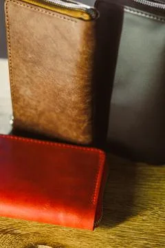 This collection features three elegantly designed leather wallets in deep bro Stock Photos