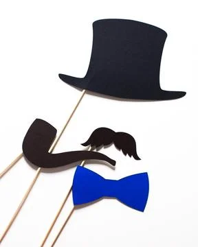 Collection of festive props including a black top hat, pipe, blue bow tie, and Stock Photos