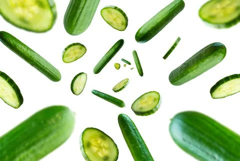 Collection of fresh Cucumbers falling isolated on white background. Selective Stock Photos