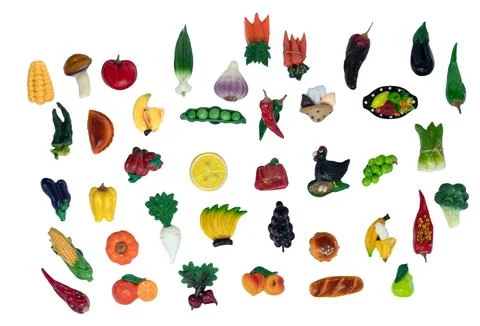 A collection of fruit and vegetable fridge magnets in different shapes and .. Stock Illustration