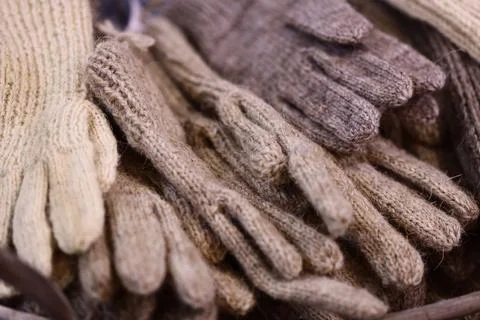 A collection of gloves placed on a flat surface, suitable for use as a prop in Stock Photos