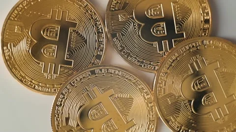 A collection of gold coins is displayed in a close-up format, highlighting their Stock Footage 338297747