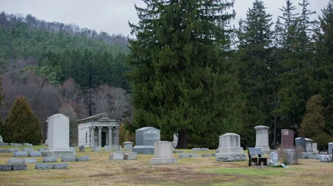 A collection of graves in an old cemetery on a cloudy day Stock Footage 58446264