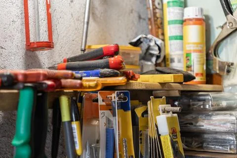 A collection of hand tools and hardware supplies organized on wooden workshop Stock-Fotos