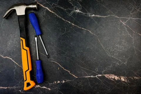 A collection of hand tools creatively arranged on a stunning marble background Stock Photos