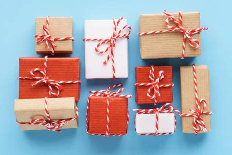 Collection of handcrafted gift boxes on light blue background. Stock Photos