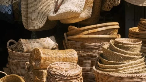 Collection of handmade wicker baskets, trays, hats and weaving bags displayed at Stock Footage 315854554