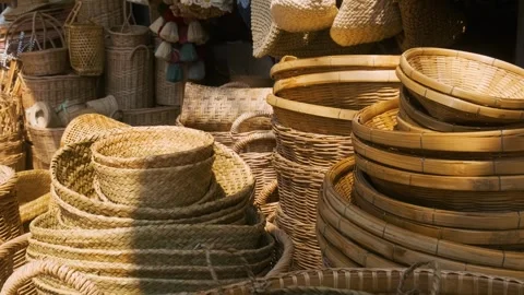 Collection of handmade wicker baskets, trays, hats and weaving bags displayed at Stock Footage 315856665