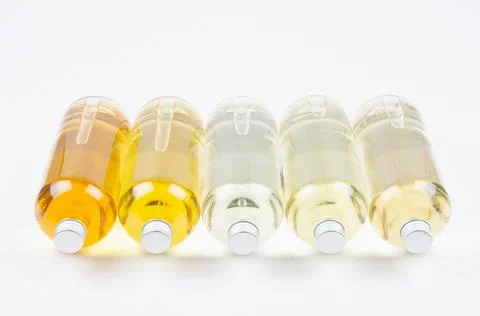 Collection lying transparent bottles with different pale colors liquid, cosme Stock Photos