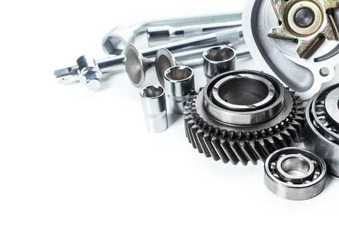 Collection of mechanical components and tools arranged neatly on a white Stock Photos