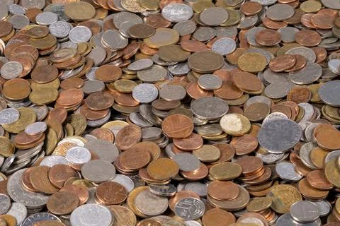 Collection of mixed coins displayed on a flat surface Stock Photos