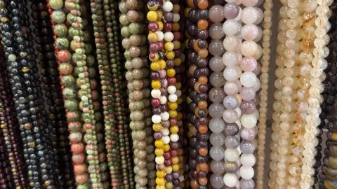 A collection of multicolored gemstone beads Stock Footage 315943938