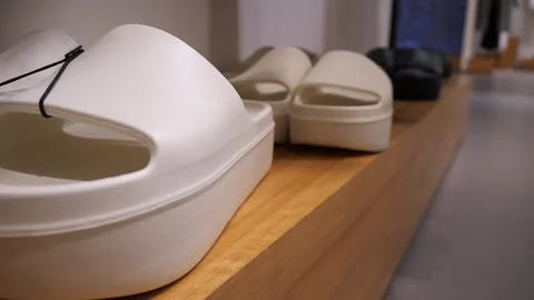 Collection of new flip flops on the store shelf, standing in a row. Fashion. Stock Footage 280708604