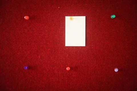 Collection of note papers pinned on a red board ready for filling in quotes. Stock Photos