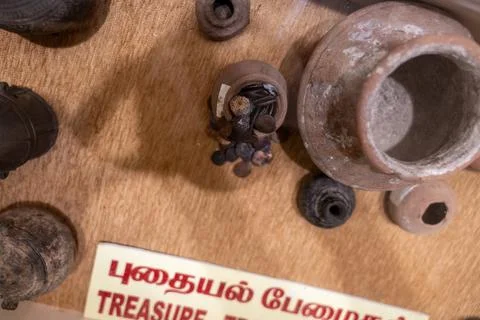 A collection of old items on a table with a sign that says "Treasure". in C.. 스톡 사진