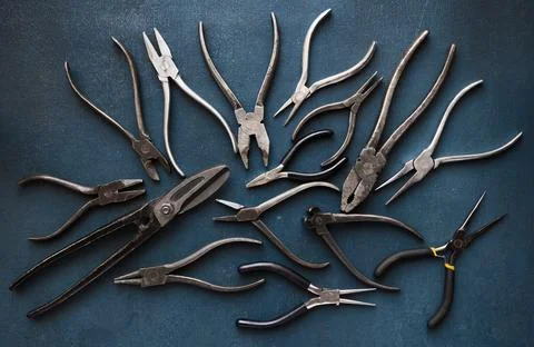 Collection of old metalworking handtools on a rough blue background, top view Stock Photos