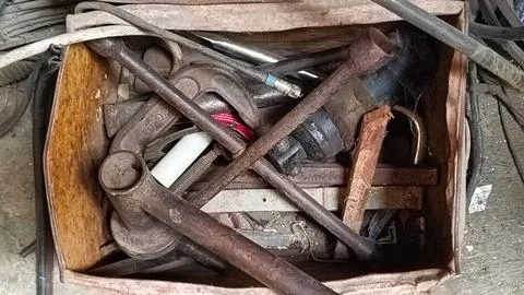Collection of Old Rusty Tools in a Box on Workshop Floor Stock Photos