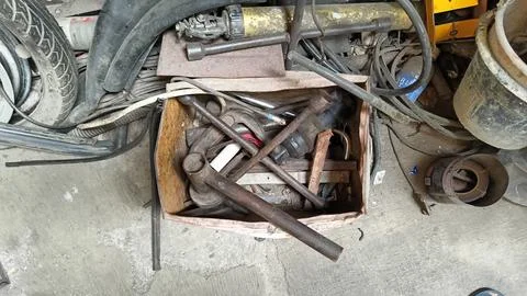 Collection of Old Rusty Tools in a Box on Workshop Floor Stock Photos