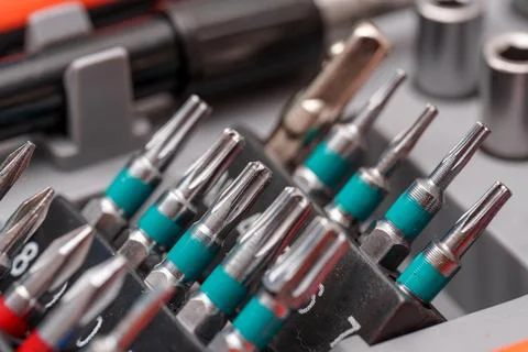 Collection of precision screwdriver bits arranged in tool organizer for DIY.. Stock Photos