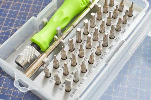 Collection of precision screwdriver bits with handle. Photos