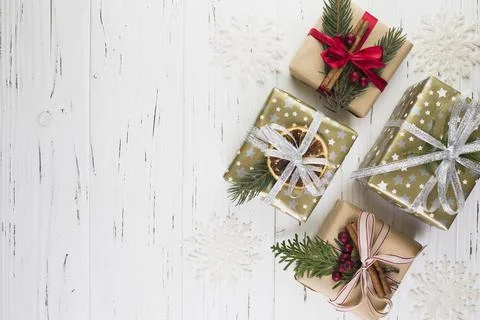 Collection of present boxes in christmas wrap between ornament snowflakes. High Stock Photos