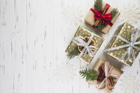 Collection of present boxes in christmas wrap between ornament snowflakes Stock Photos