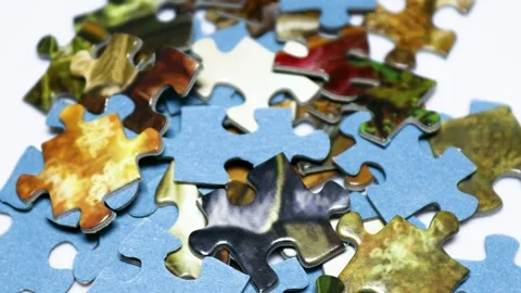 A collection of puzzle pieces stacked on a table Stock Footage 345168479
