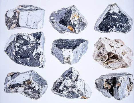 A collection of rough raw diamonds in various natural shapes and sizes Stock Photos
