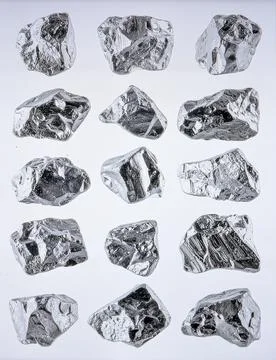 A collection of rough raw diamonds in various natural shapes and sizes, iso.. Stock Photos